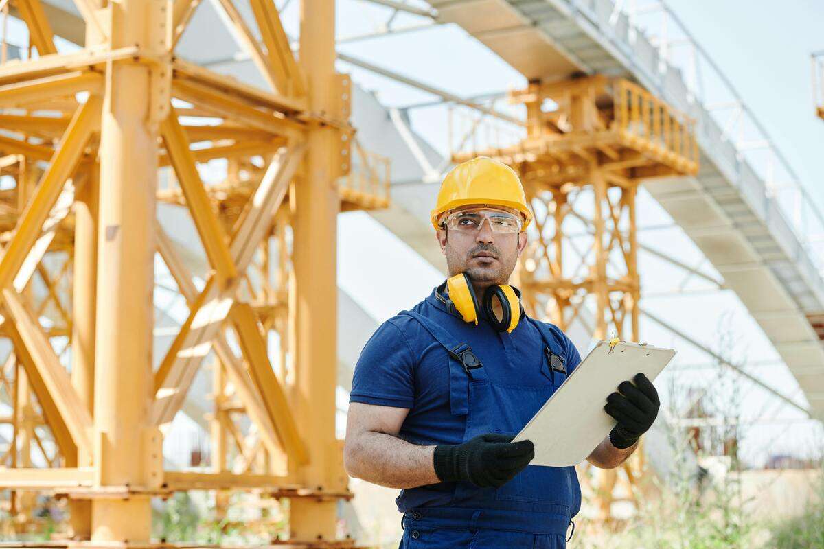A construction worker holding a document