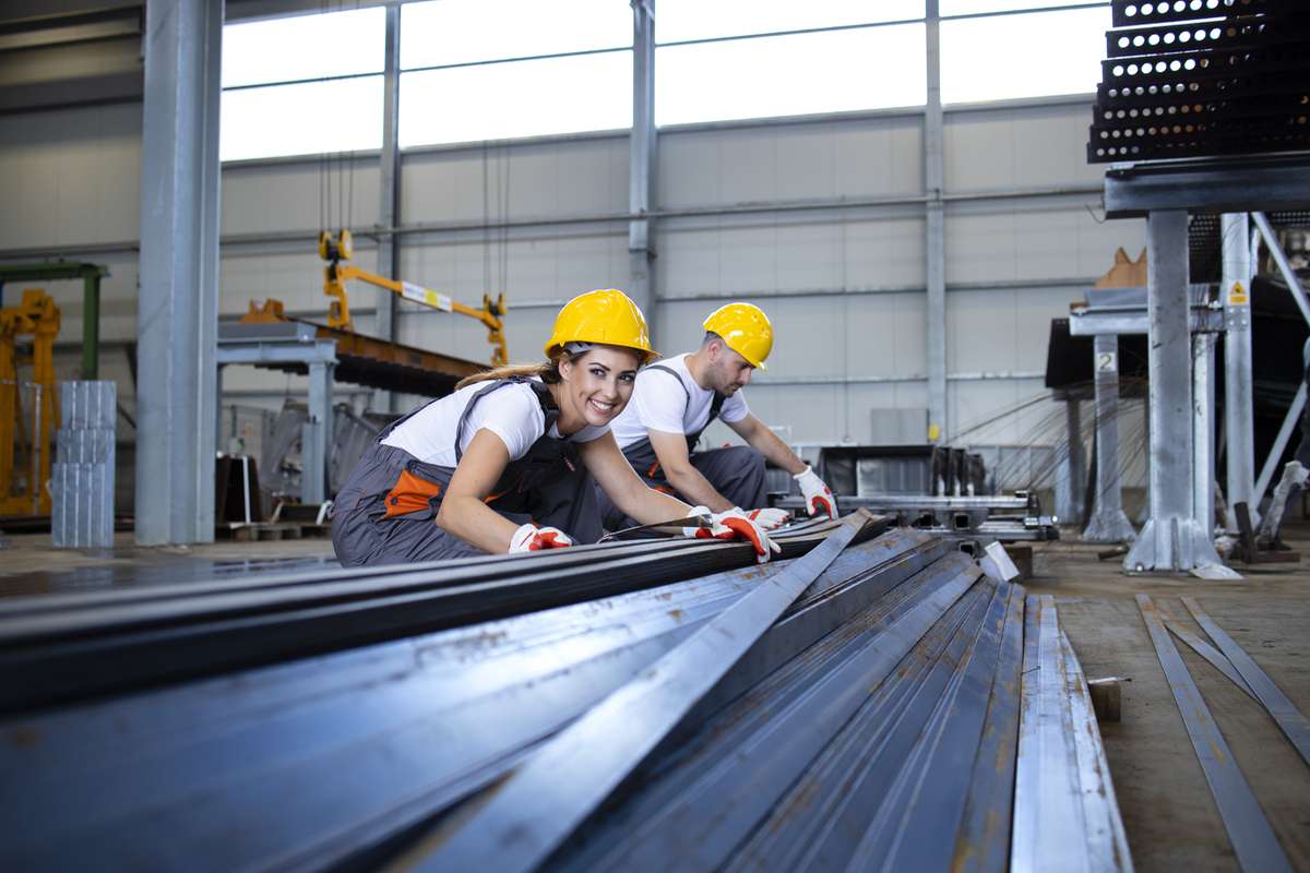Workers carefully examining the metal for corrosion treatment