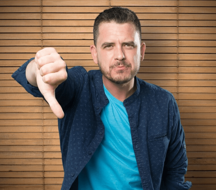 A man showing a thumbs down on metal garage building