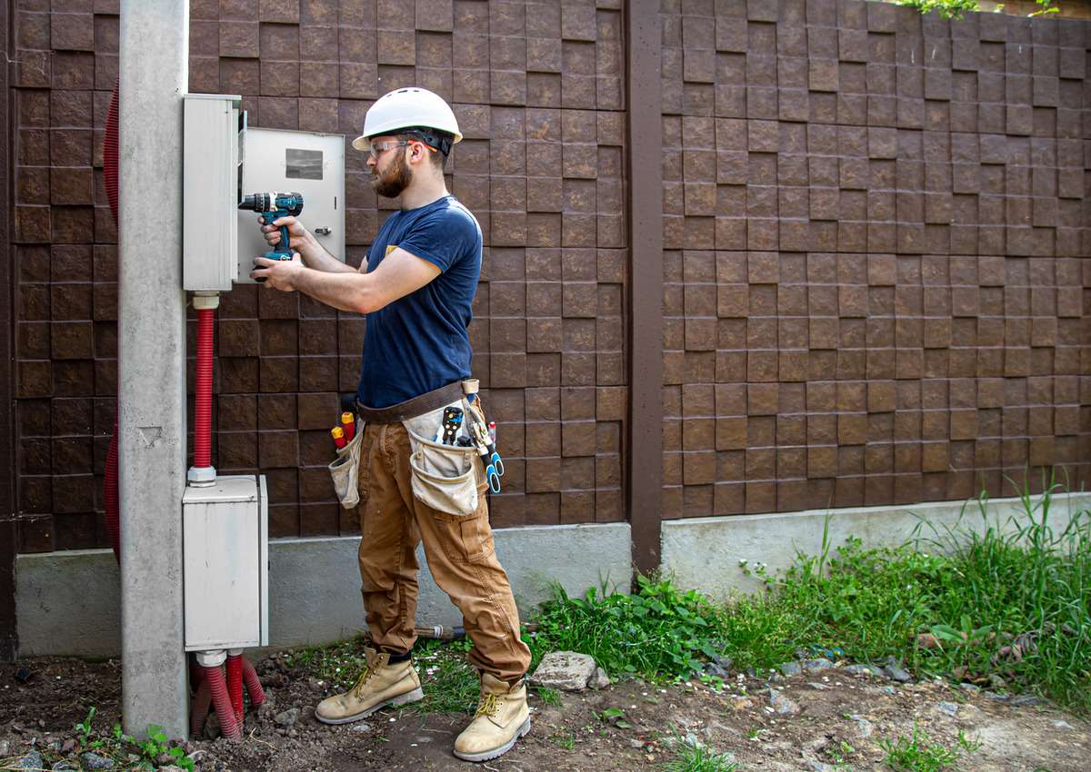 Electrician connecting electrical cables for electricity set-up