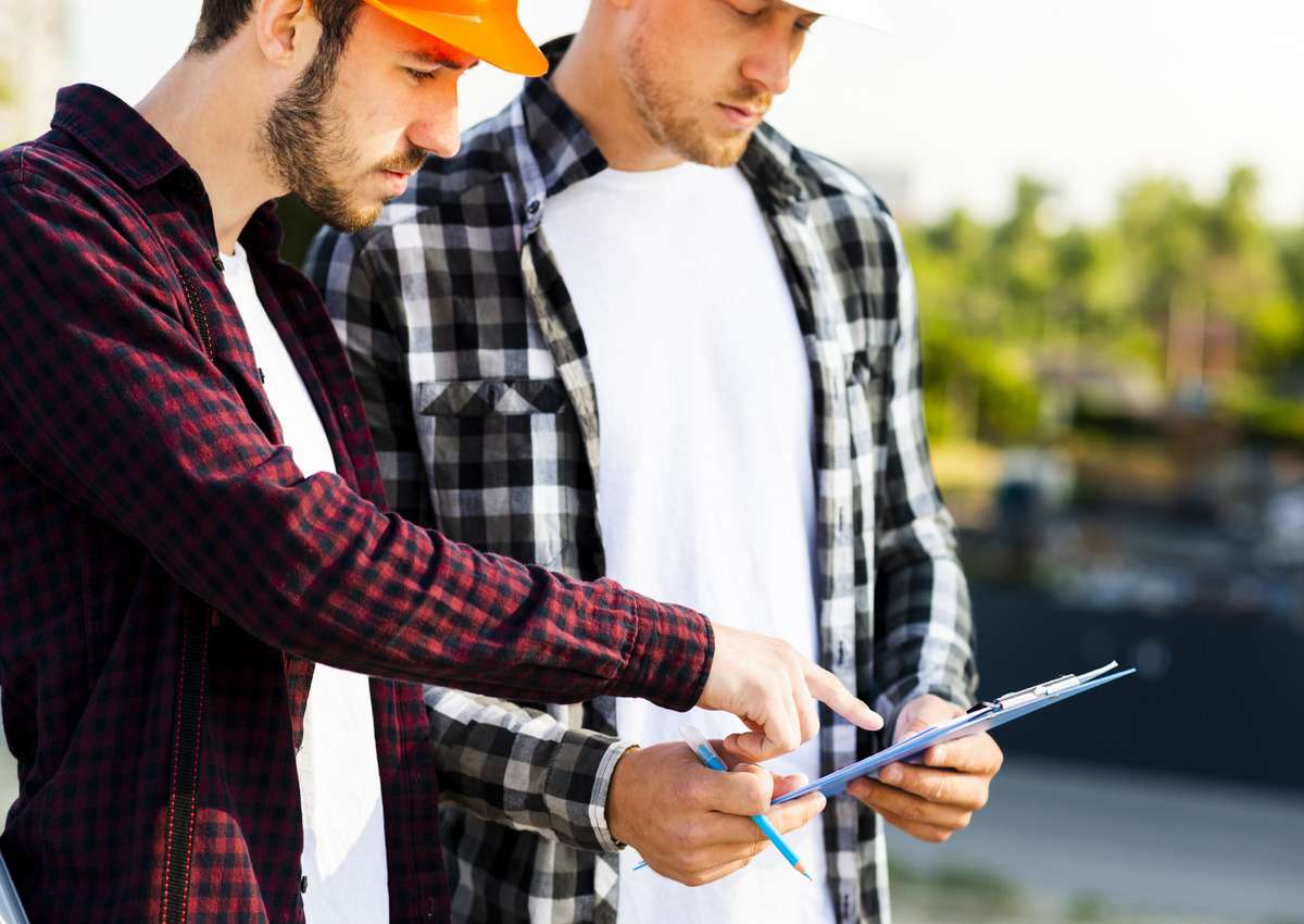 Engineer and workers checking the permits for site constructions