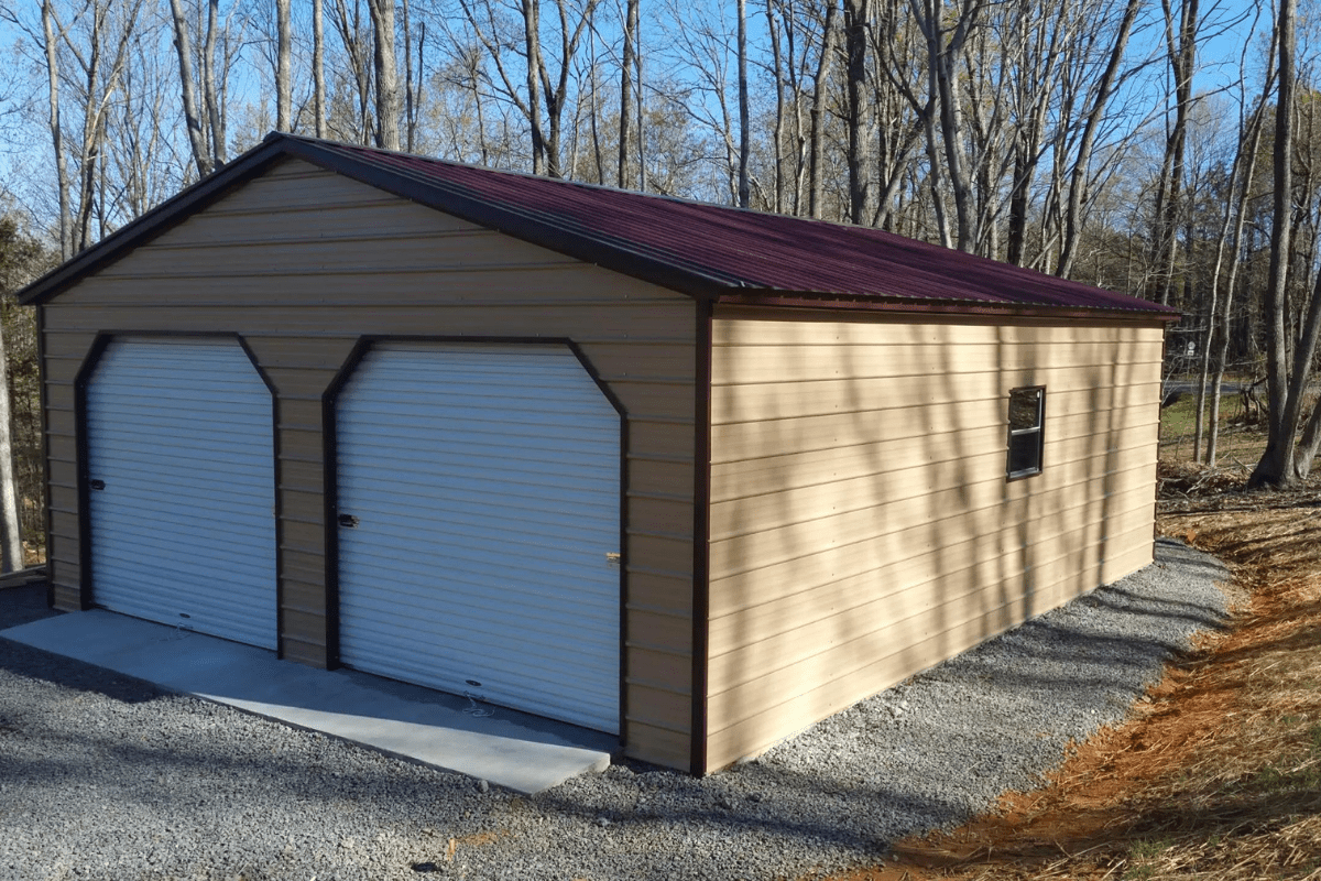 Metal garage with a regular roof and trees in the background