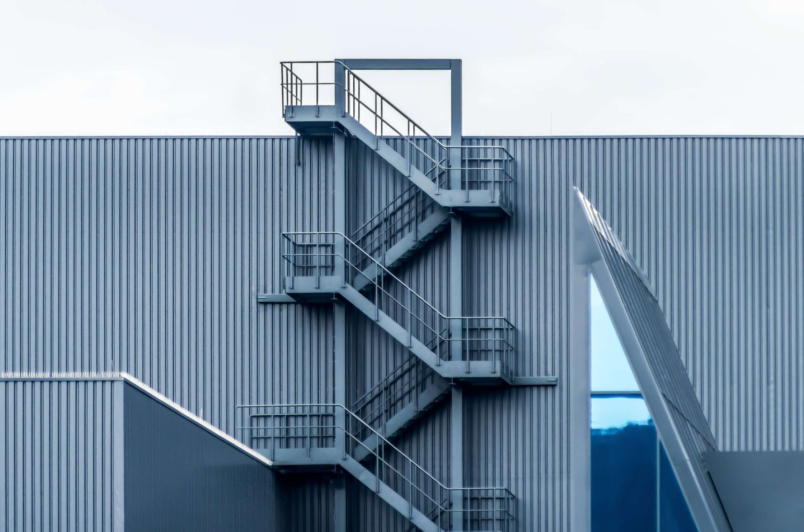 An image of a metal building highlighting the emergency stairs 