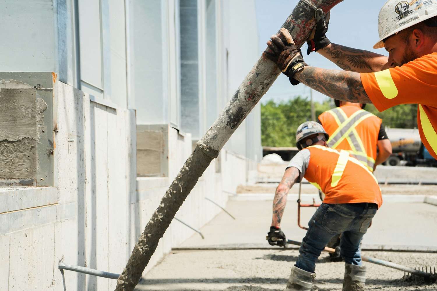 A construction worker pouring concrete