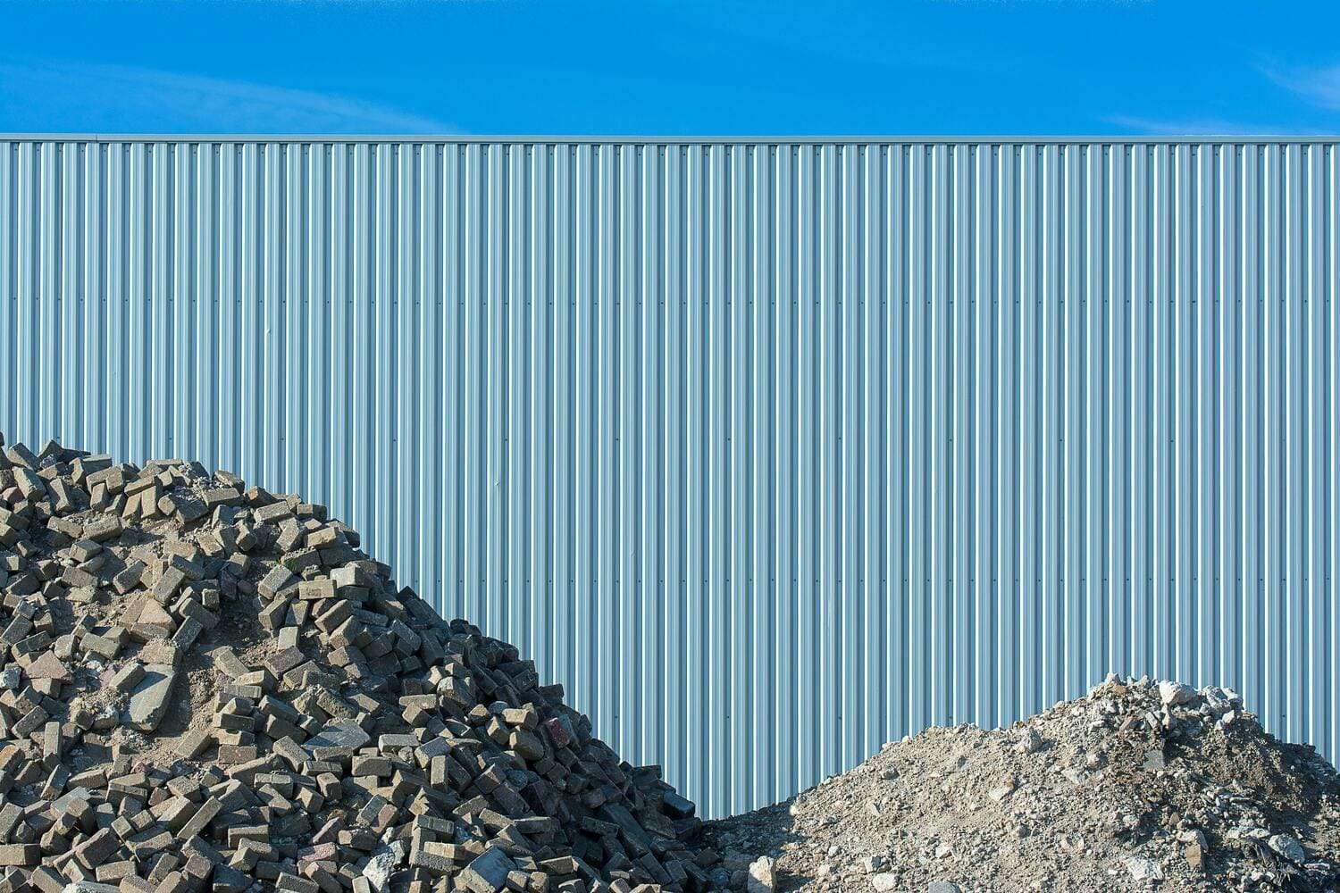 Construction waste beside a metal building