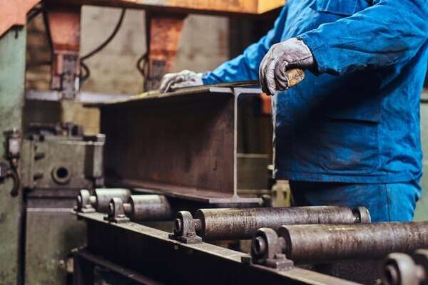 A worker trying to cut the steel with high precision measurements