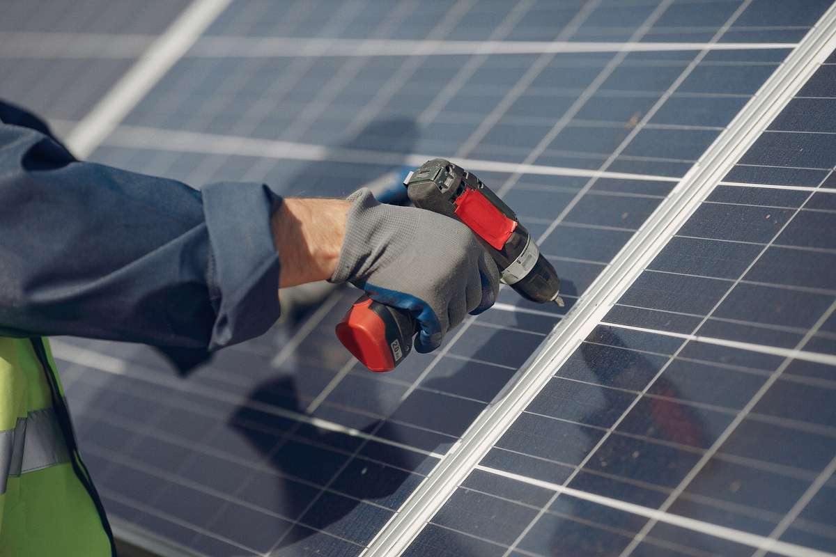 A person setting up solar panels