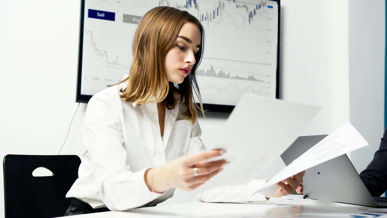 A woman comparing documents