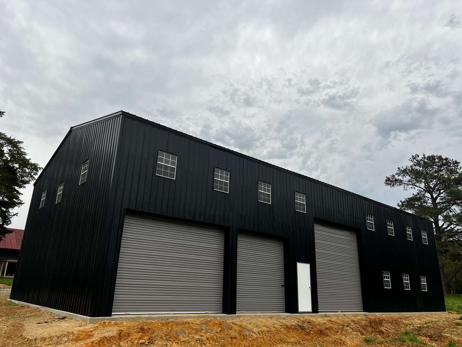 A huge three-door commercial metal building.