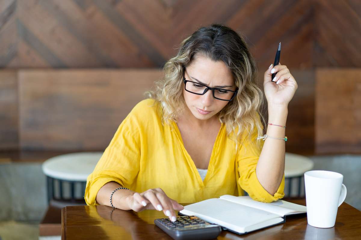 A woman using a calculator.