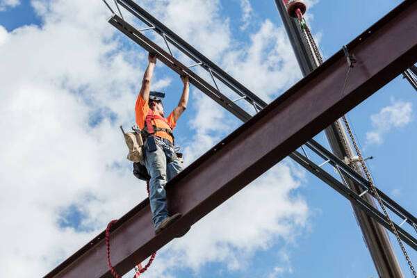 A person inspecting a steel building