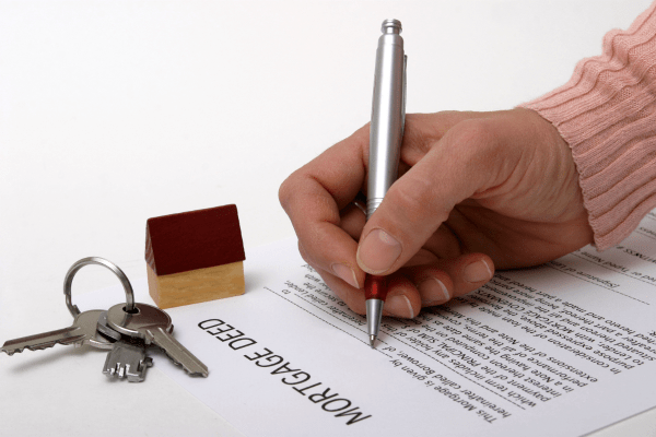 Signing a mortgage deed for a metal building