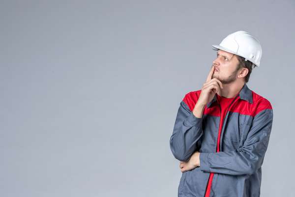 Construction worker thinking about foundation options for a future metal building project.
