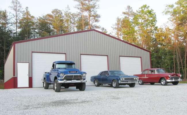 Metal garage types you can choose from with three classic cars parked outside.